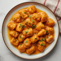 Ñoquis de calabaza con crema fungui y shitakes al wok